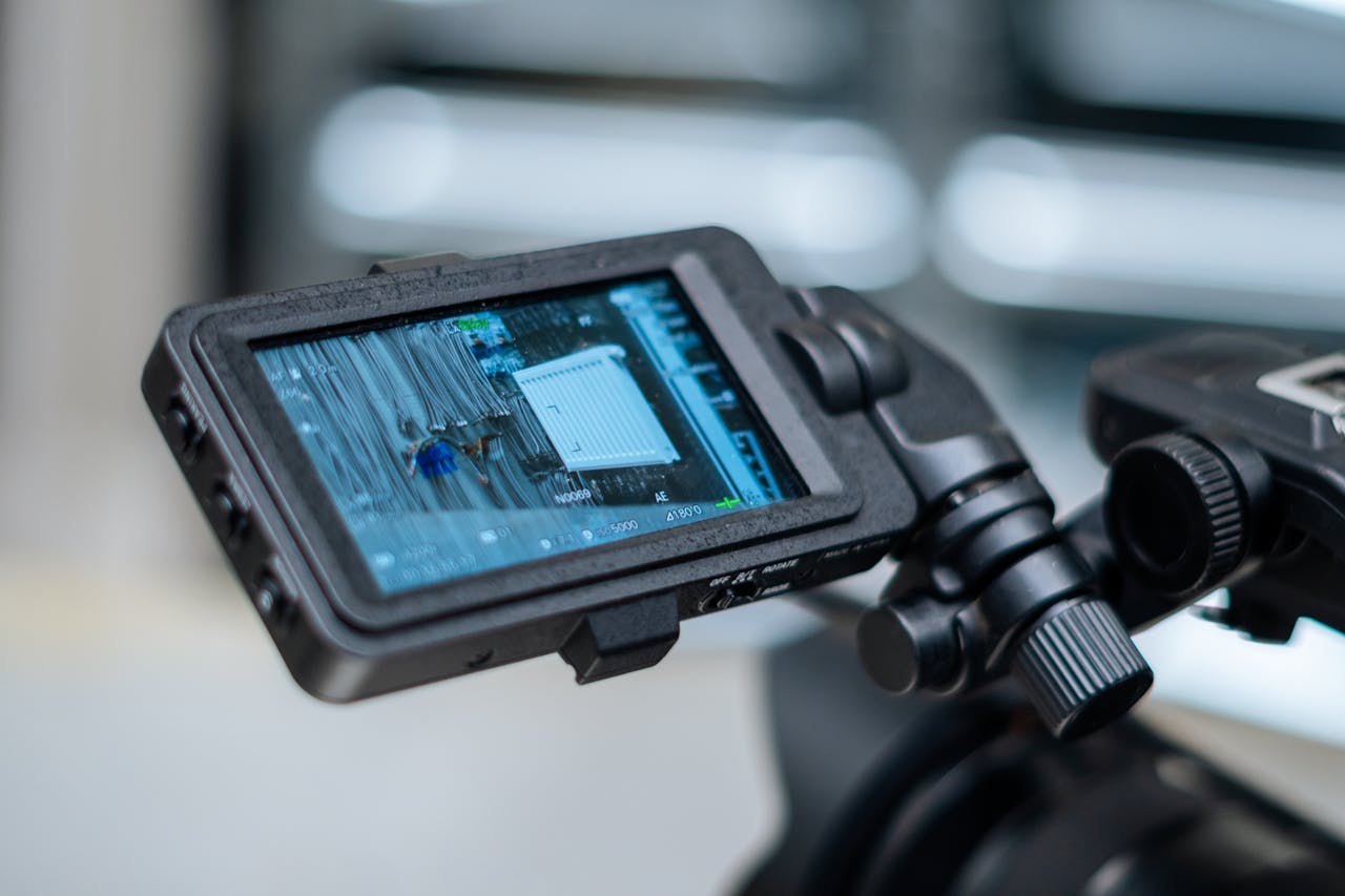 creative-02 Close-up view of a camera monitor displaying captured footage with detailed settings.