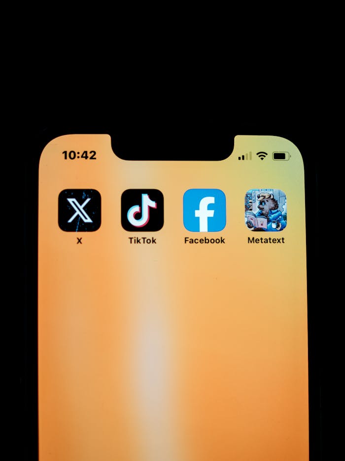 creative-03 Close-up of smartphone displaying social media apps on a yellow background.
